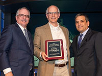 Professor DeGrazia (middle) receiving the Distinguished Scholar Award