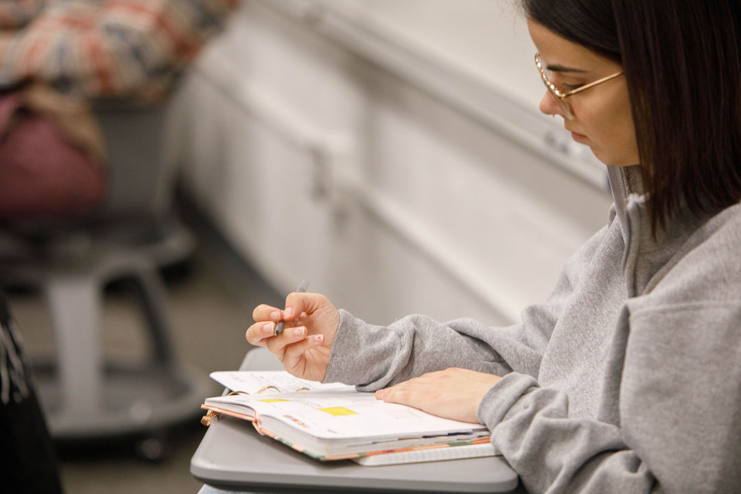 A student writing on her notebook