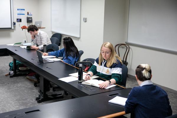 Students writing in Dr. Gail Weiss class
