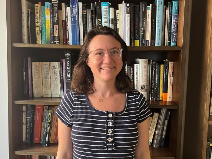 Photo of Courtney Cooperman against a bookcase