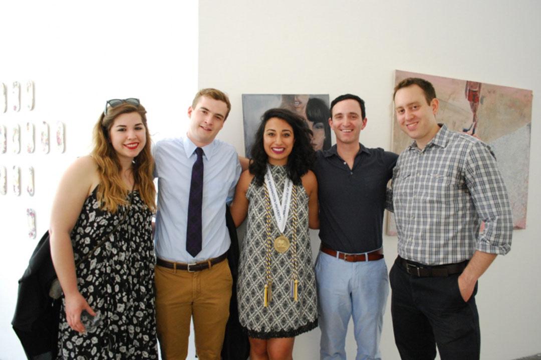A group of Philosophy graduates stand with professors at a graduation event